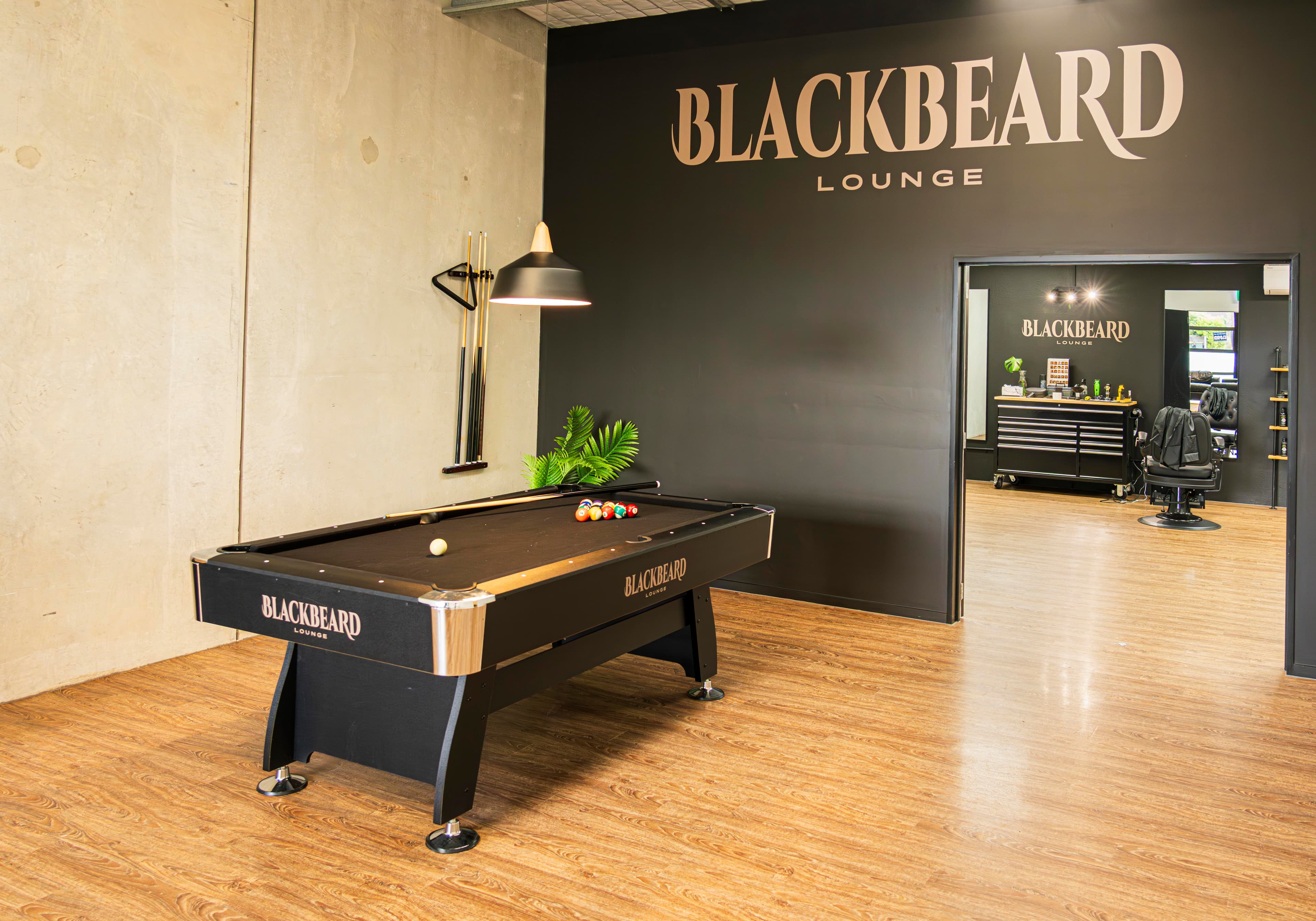 The pool table and barbering space inside Blackbeard Lounge